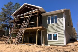 Redemption Construction general contractor in all things in home building and renovations has over 40 years experience in siding new and old home builds with sage green vinyl