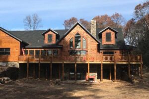 Large stained wood siding log home style built by Redemption Construction general contractor in Wisconsin Rapids