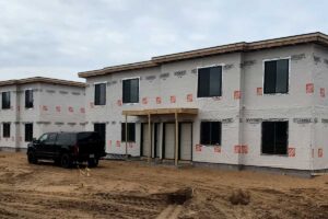 Commercial housing apartment and condo in building phase with weather wrap being applied by Redemption Construction general contractor in Wisconsin Rapids