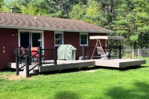 Redemption Construction general contractor in all things in home building and renovations has over 40 years experience in custom grey and black deck burgundy siding building