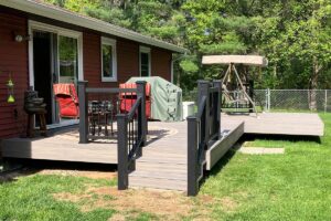 Redemption Construction general contractor in all things in home building and renovations has over 40 years experience in custom grey and black deck burgundy siding building